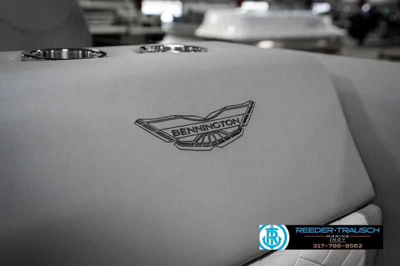 Slide: The Image of 2025 Bennington 25 LPD boat seat with logo and cup holders. - 48
