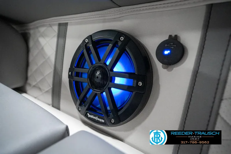 Slide: The Image of Illuminated speaker on 2025 Bennington 25 LPD boat interior, featuring blue LED lighting. - 49