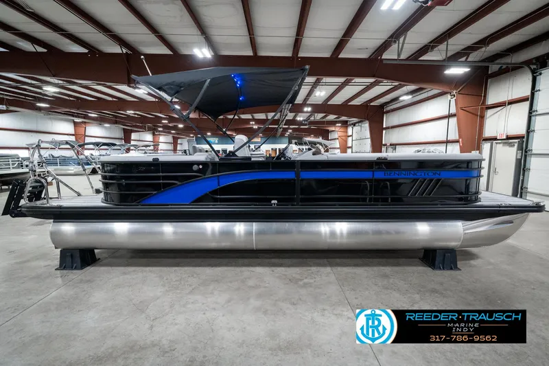 Slide: The Image of 2025 Bennington 25 LPD pontoon boat in showroom, featuring sleek design and modern amenities. - 7