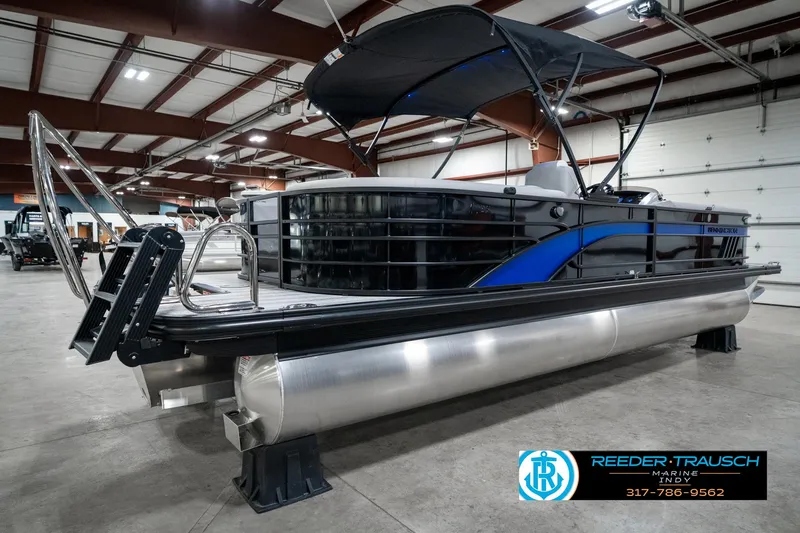 Slide: The Image of 2025 Bennington 25 LPD pontoon boat in showroom, featuring sleek design and modern amenities. - 8