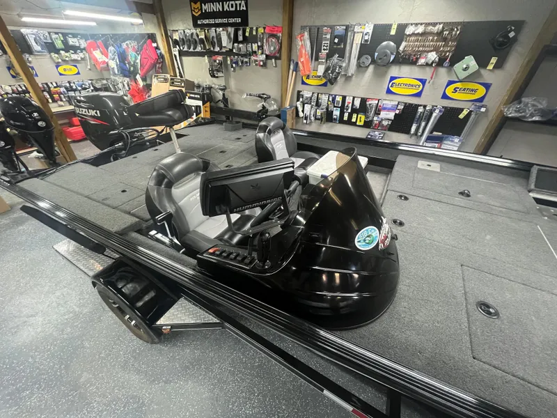 Slide: The Image of 2016 Polar Kraft Bass TX 195 Pro boat in a showroom with fishing gear. - 10