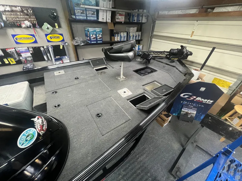 Slide: The Image of 2016 Polar Kraft Bass TX 195 Pro boat in a garage, showcasing fishing deck and equipment. - 11