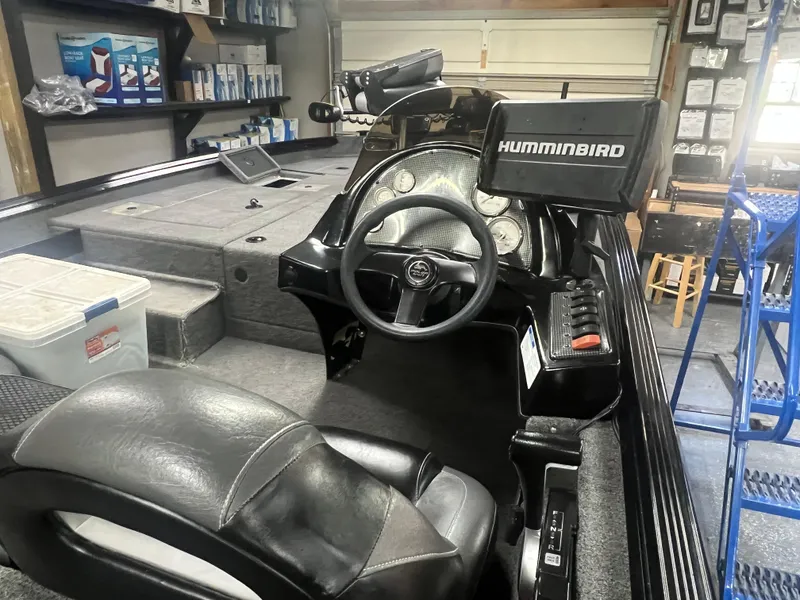 Slide: The Image of 2016 Polar Kraft Bass TX 195 Pro boat interior with steering wheel and Humminbird electronics. - 12