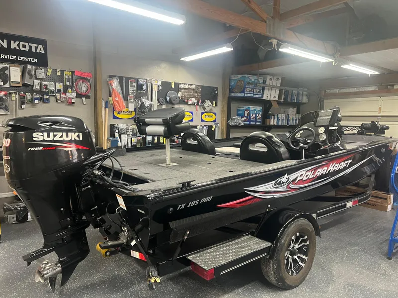 Slide: The Image of 2016 Polar Kraft Bass TX 195 Pro boat in a workshop with Suzuki engine. - 13