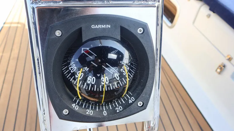 Slide: The Image of Garmin compass on 2018 Hanse 505 yacht, wooden deck background. - 10