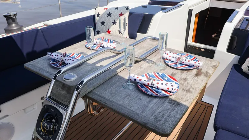 Slide: The Image of Outdoor dining setup on 2018 Hanse 505 yacht with nautical-themed tableware. - 11
