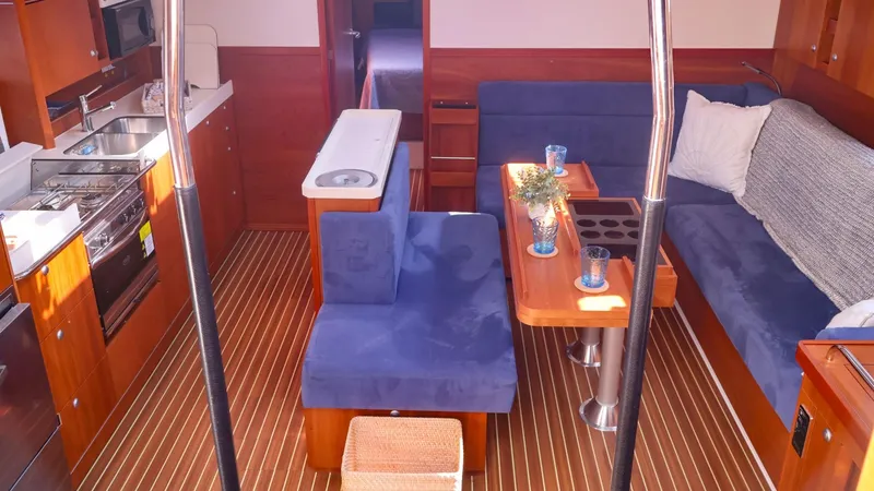 Slide: The Image of Interior of 2018 Hanse 505 yacht with blue seating and wooden accents. - 13