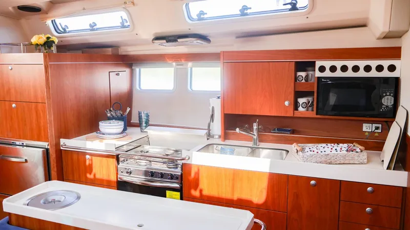 Slide: The Image of Interior of 2018 Hanse 505 yacht kitchen with wooden cabinetry and modern appliances. - 15