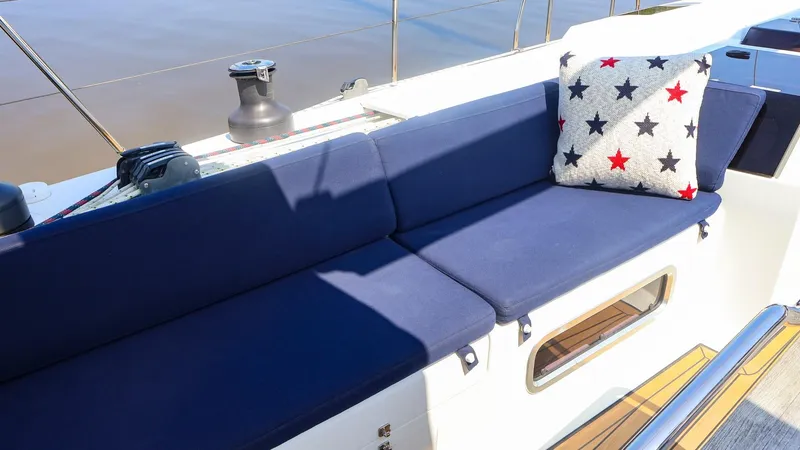 Slide: The Image of Blue cushioned seating on 2018 Hanse 505 yacht with star-patterned pillow. - 17