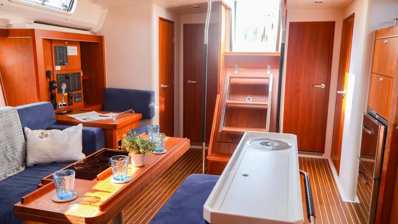 Slide: The Image of Interior of 2018 Hanse 505 yacht with modern wood finish and cozy seating area. - 19