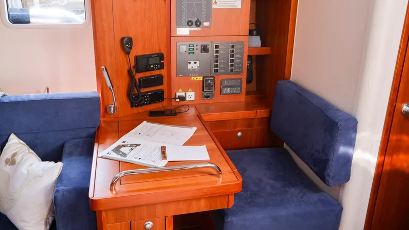 Slide: The Image of Interior of 2018 Hanse 505 yacht with navigation station and blue seating. - 22