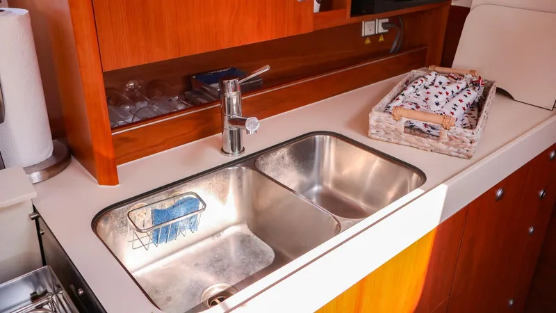 Slide: The Image of Modern kitchen sink in 2018 Hanse 505 yacht with wooden cabinetry. - 26