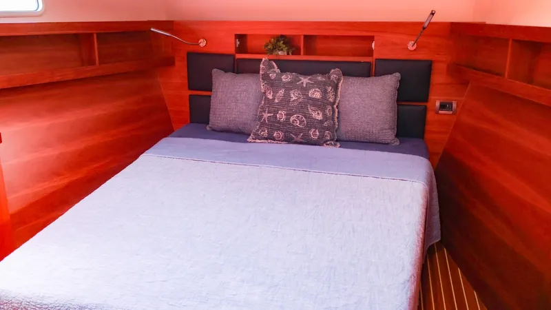 Slide: The Image of Cozy cabin interior of 2018 Hanse 505 yacht with wooden finish and comfortable bedding. - 30