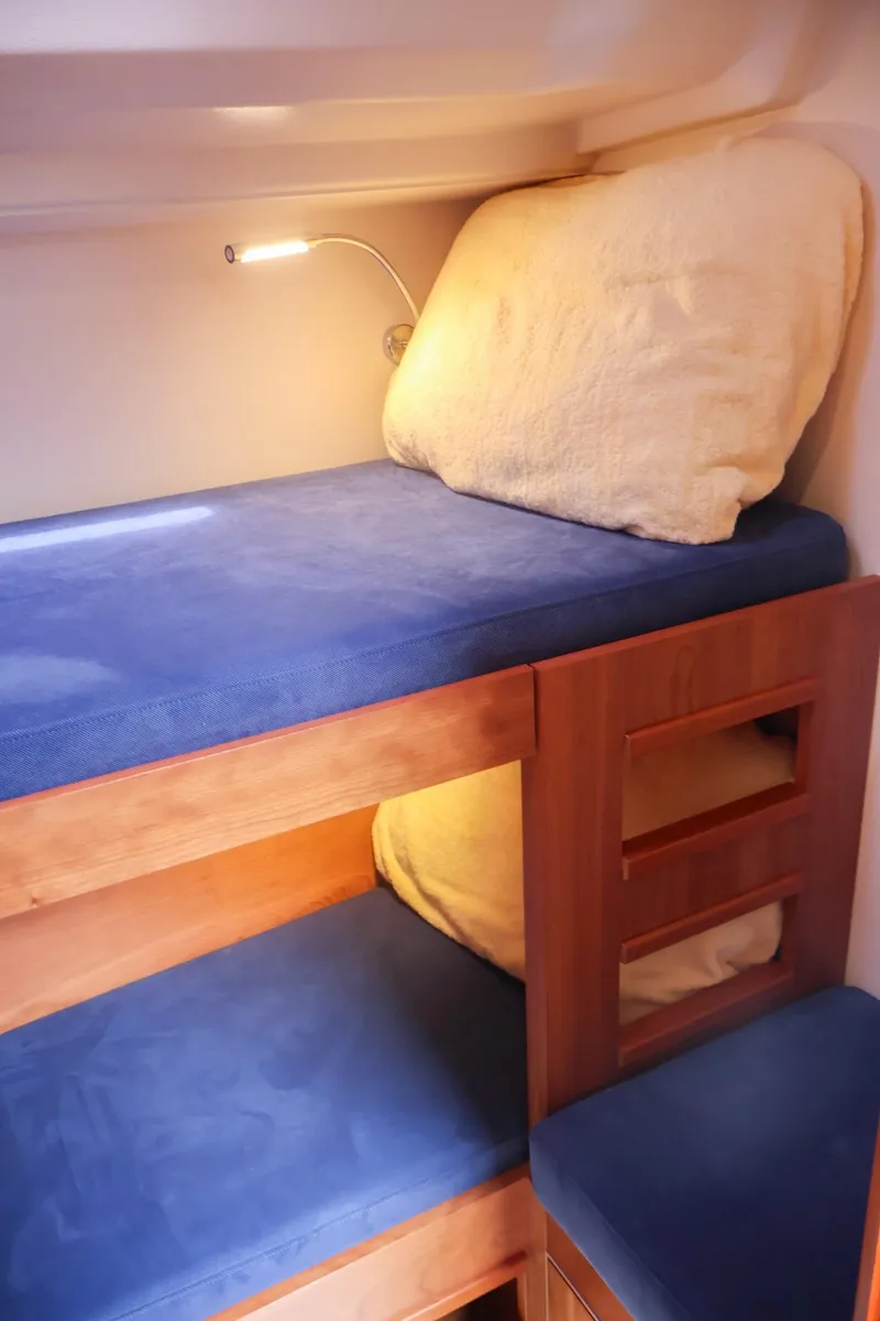 Slide: The Image of Bunk beds in 2018 Hanse 505 yacht cabin with blue cushions and reading light. - 33