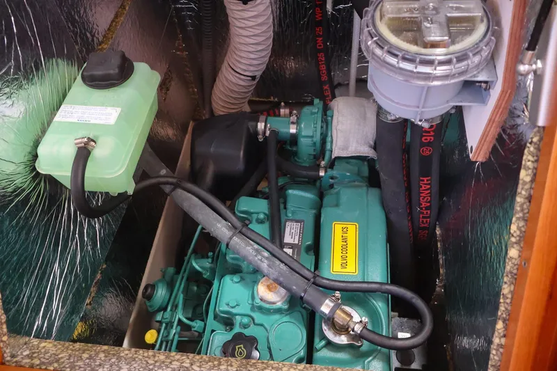 Slide: The Image of Engine compartment of a 2018 Hanse 505 yacht, featuring a green marine engine. - 36