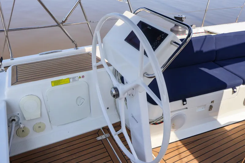 Slide: The Image of Steering wheel of 2018 Hanse 505 yacht with wooden deck and blue seating. - 6