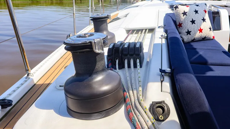 Slide: The Image of Deck of 2018 Hanse 505 yacht with winch, ropes, and star-patterned cushion. - 8