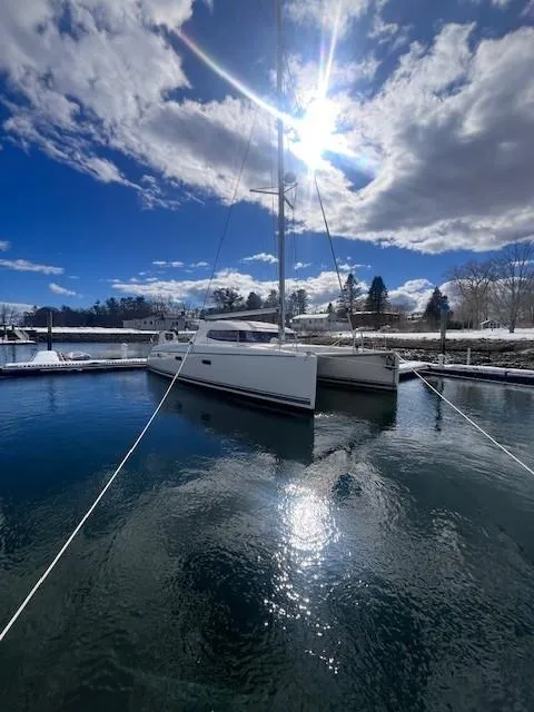Slide: The Image of Nautitech 402 catamaran, 2011 model, docked under a bright sunlit sky. - 11