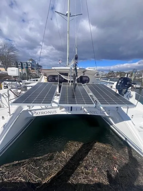 Slide: The Image of Nautitech 402 catamaran with solar panels, docked under cloudy skies, 2011 model. - 13