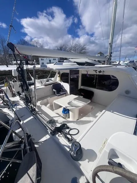 Slide: The Image of Nautitech 402 catamaran, 2011 model, featuring spacious deck and seating area under a blue sky. - 16