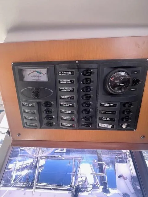 Slide: The Image of Control panel of a 2011 Nautitech 402 catamaran with switches and gauges. - 21