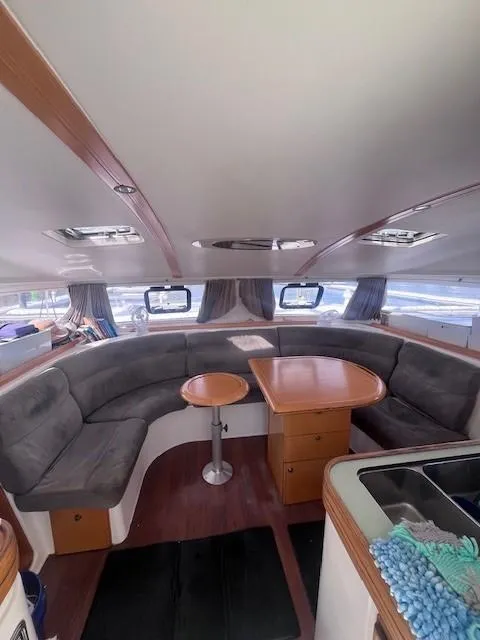Slide: The Image of Interior of 2011 Nautitech 402 catamaran with cozy seating and wooden table. - 22