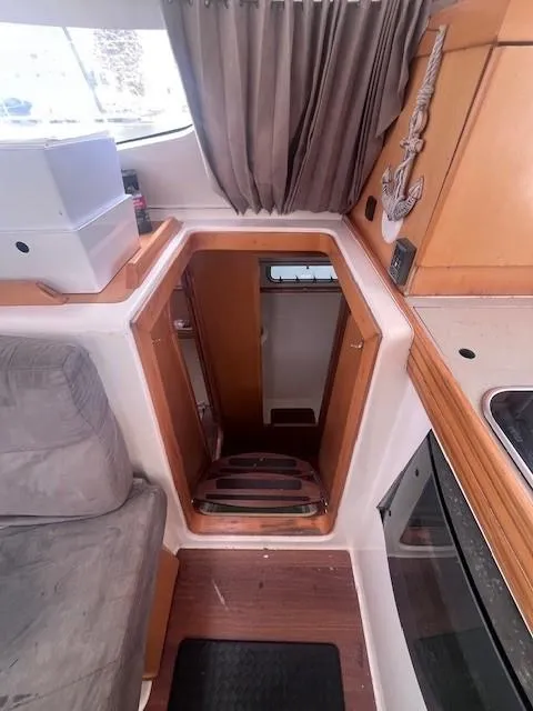 Slide: The Image of Interior of 2011 Nautitech 402 catamaran, featuring a cozy cabin entrance and wooden accents. - 25