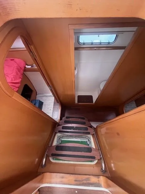 Slide: The Image of Interior view of 2011 Nautitech 402 yacht, featuring wooden stairs and cabin access. - 26