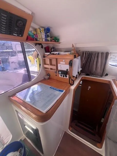 Slide: The Image of Interior view of a 2011 Nautitech 402 catamaran, featuring navigation equipment and storage. - 31