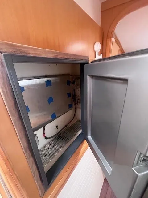 Slide: The Image of Open refrigerator in 2011 Nautitech 402 yacht interior, showing empty storage space. - 34