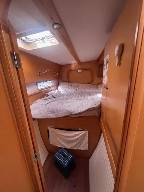 Slide: The Image of Cozy cabin interior of 2011 Nautitech 402 catamaran with wooden finish and comfortable bedding. - 35