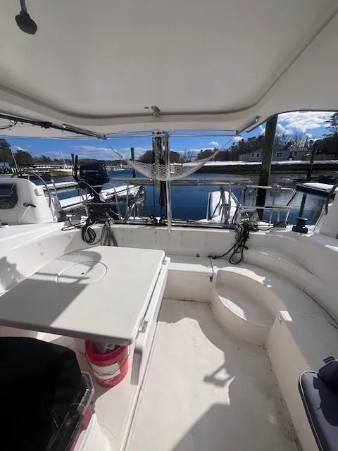 Slide: The Image of 2011 Nautitech 402 catamaran cockpit with seating and table, docked at marina. - 38