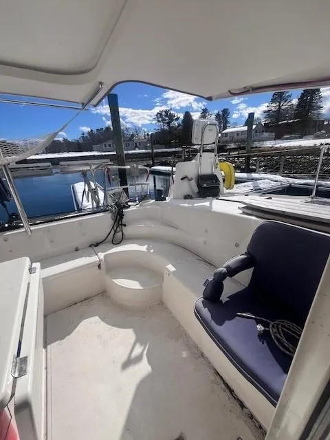 Slide: The Image of 2011 Nautitech 402 yacht cockpit with seating, docked by a scenic waterfront. - 39