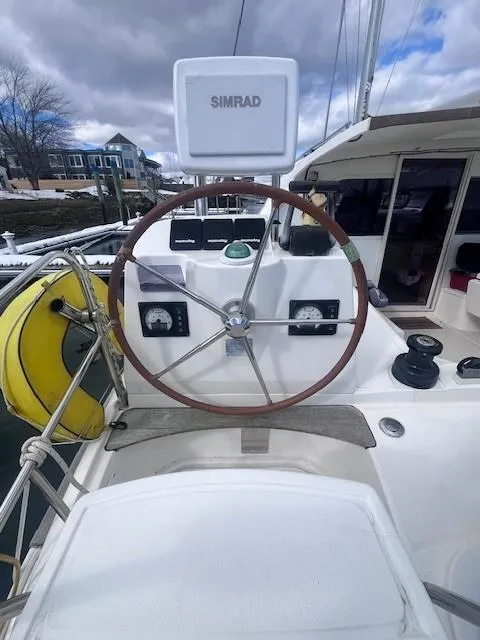Slide: The Image of Nautitech 402 catamaran helm with Simrad equipment, 2011 model, docked under cloudy skies. - 40