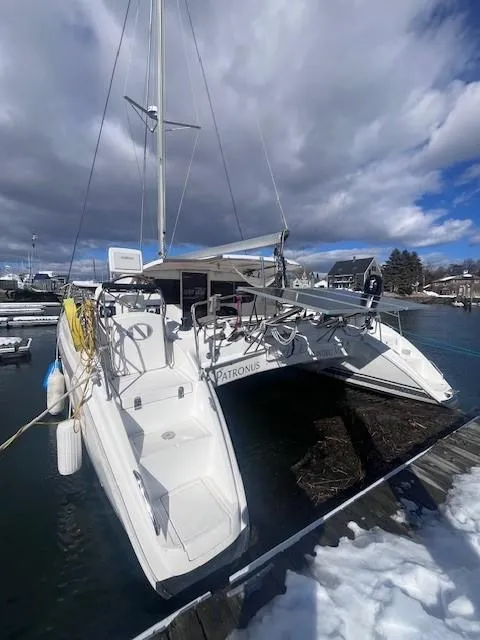 Slide: The Image of Nautitech 402 catamaran, 2011 model, docked in a snowy marina under cloudy skies. - 6