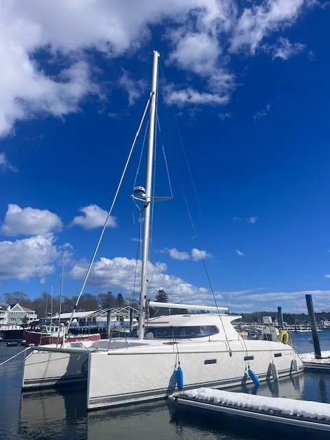 Slide: The Image of Nautitech 402 catamaran, 2011 model, docked under a vibrant blue sky. - 7