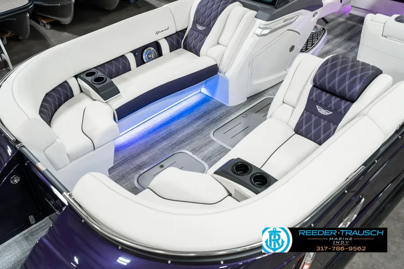 Slide: The Image of 2025 Bennington QX SB T2 boat interior with luxurious seating and ambient lighting. - 12