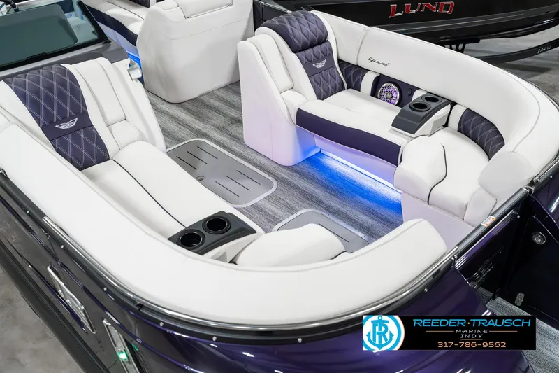 Slide: The Image of 2025 Bennington QX SB T2 boat interior with luxurious seating and ambient lighting. - 13