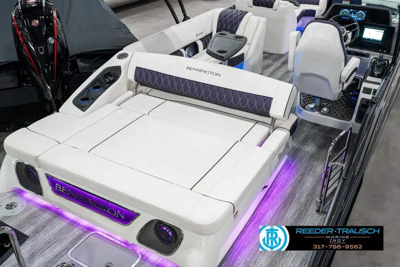 Slide: The Image of 2025 Bennington QX SB T2 boat interior with luxurious seating and ambient lighting. - 14
