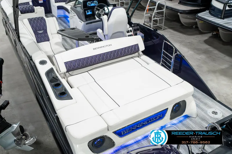 Slide: The Image of 2025 Bennington QX SB T2 luxury boat interior with plush seating and modern dashboard. - 15
