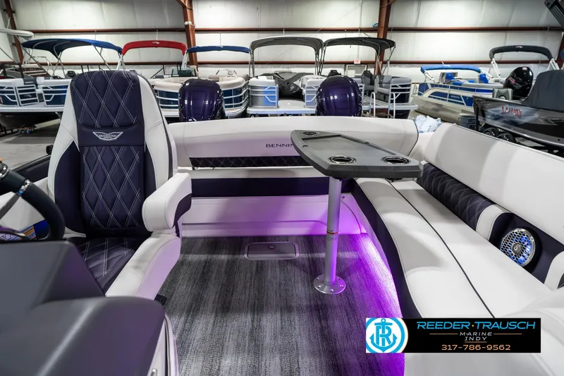 Slide: The Image of 2025 Bennington QX SB T2 pontoon boat interior with luxury seating and table. - 17