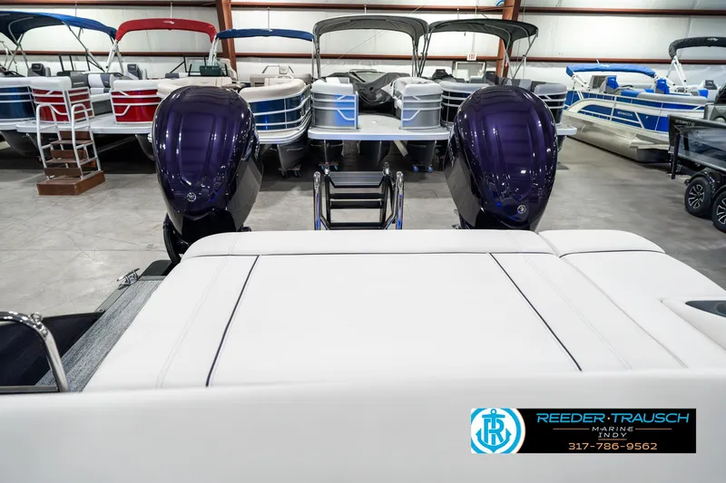 Slide: The Image of 2025 Bennington QX SB T2 pontoon boat with dual engines in showroom. - 18