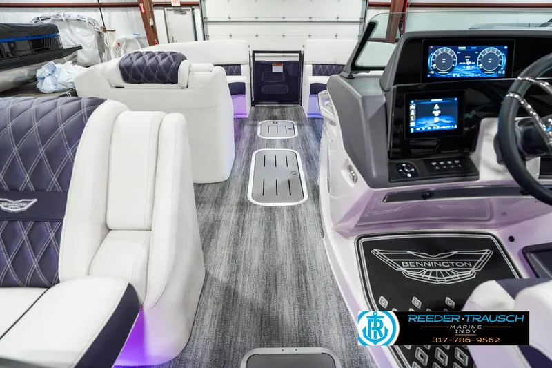 Slide: The Image of 2025 Bennington QX SB T2 boat interior with luxurious seating and modern dashboard. - 20