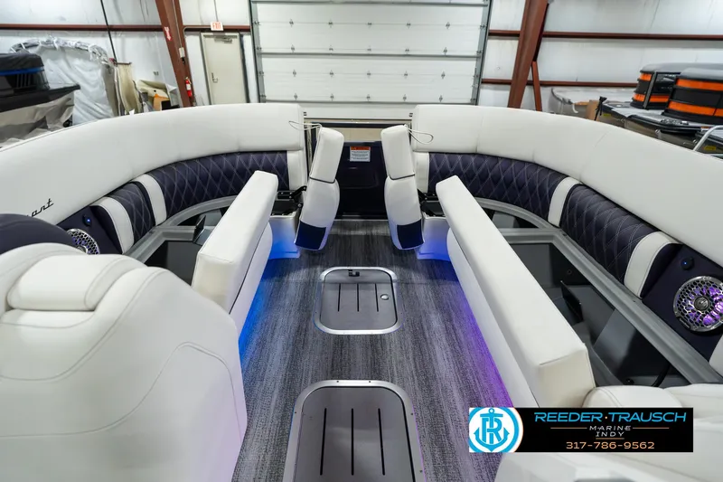 Slide: The Image of 2025 Bennington QX SB T2 boat interior with luxurious seating and ambient lighting. - 23