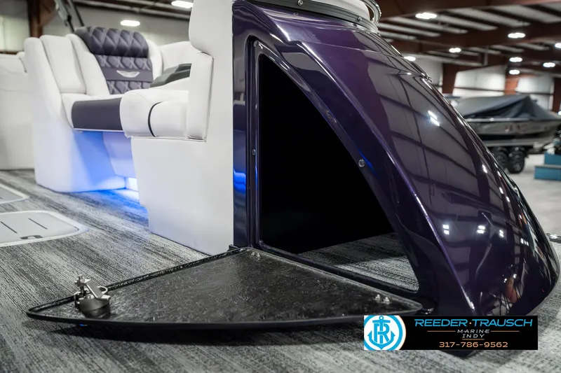 Slide: The Image of 2025 Bennington QX SB T2 boat interior with open storage compartment, luxury seating, and modern design. - 25