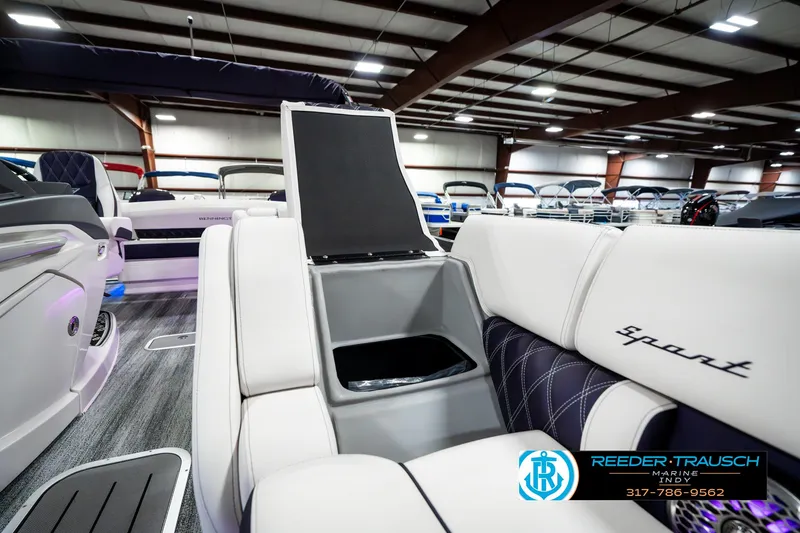 Slide: The Image of 2025 Bennington QX SB T2 boat interior with white seating and storage compartment. - 28