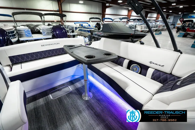 Slide: The Image of 2025 Bennington QX SB T2 boat interior with elegant seating and ambient lighting. - 29