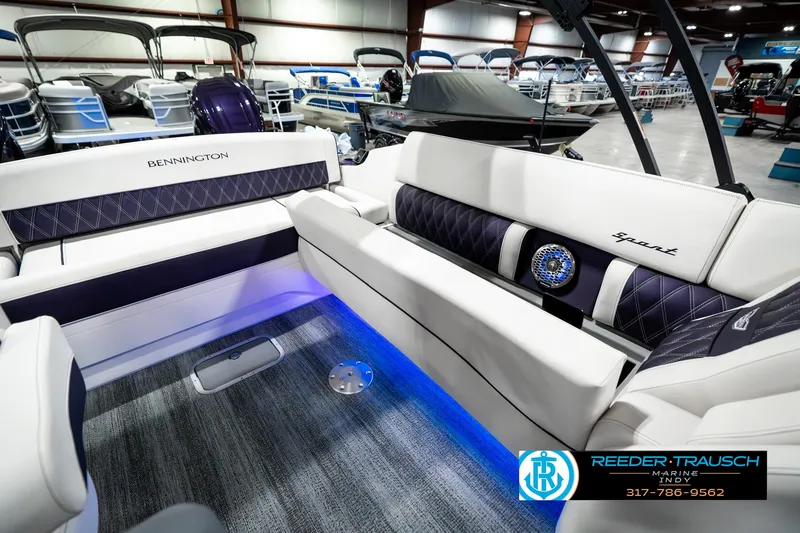 Slide: The Image of 2025 Bennington QX SB T2 boat interior with luxurious seating and ambient lighting. - 31