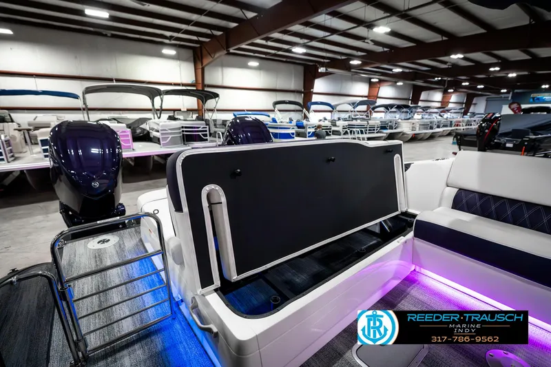 Slide: The Image of 2025 Bennington QX SB T2 pontoon boat interior with illuminated seating and storage. - 33