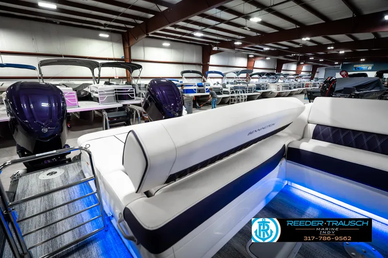 Slide: The Image of 2025 Bennington QX SB T2 boat interior with blue LED lighting in showroom. - 34